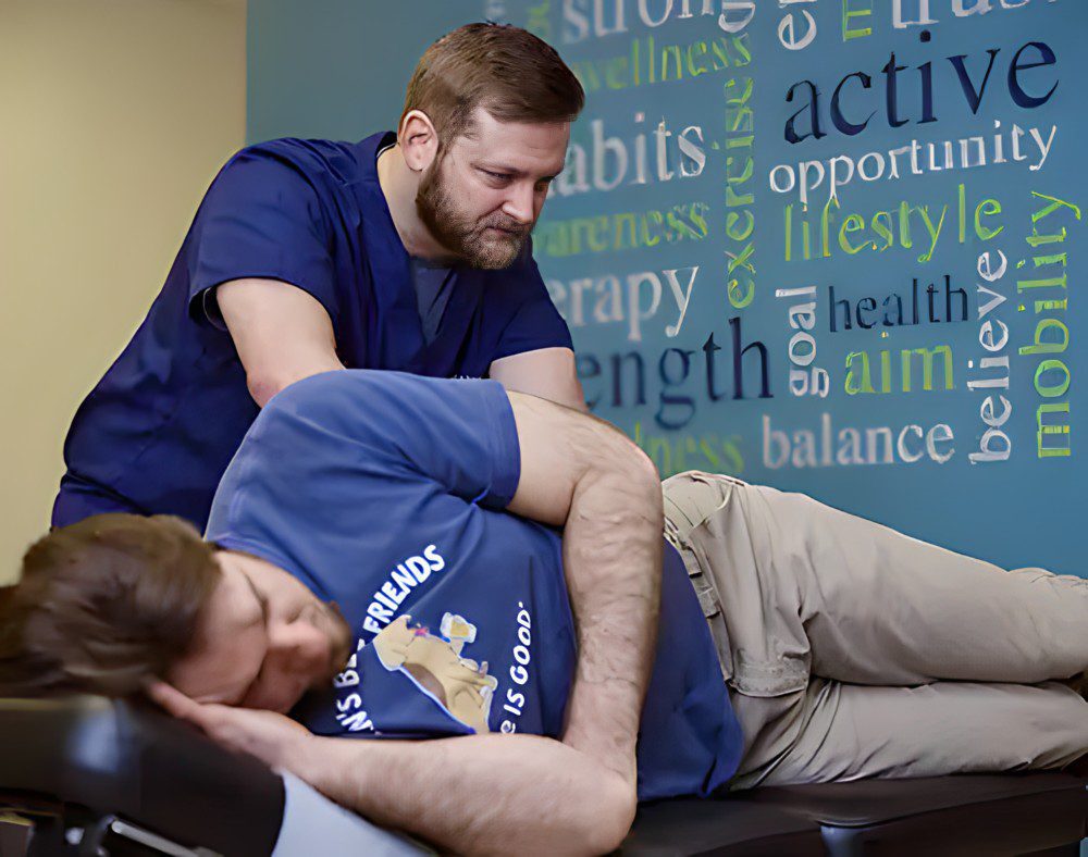 A chiropractor at Impact Health & Wellness treating a patient