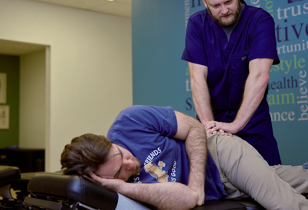 Provider examining a patient's hip for signs of pain or injury