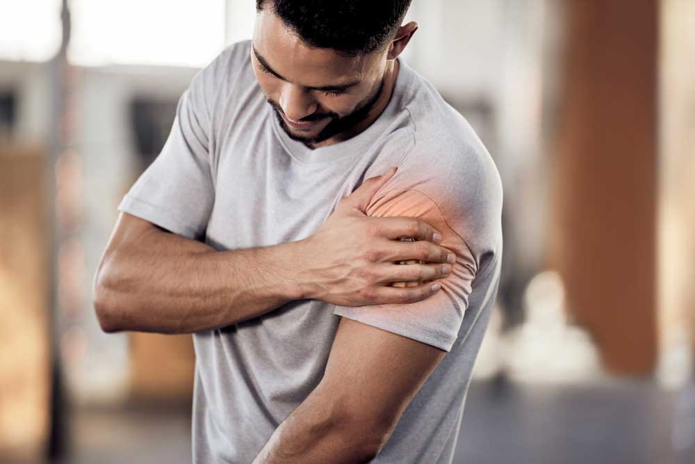 Provider examining a patient's shoulder for signs of pain or injury